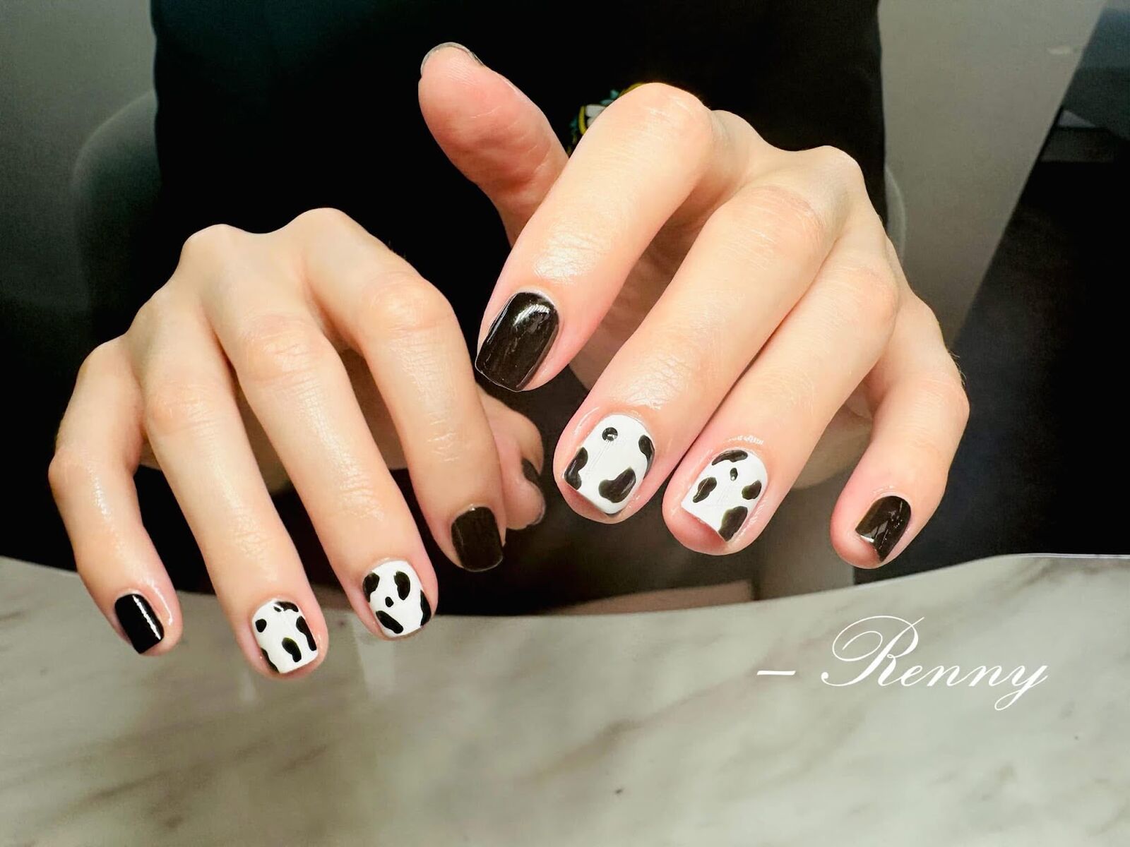 Black and white cow print and panda inspired nail art on short gel nails, Lone Tree CO