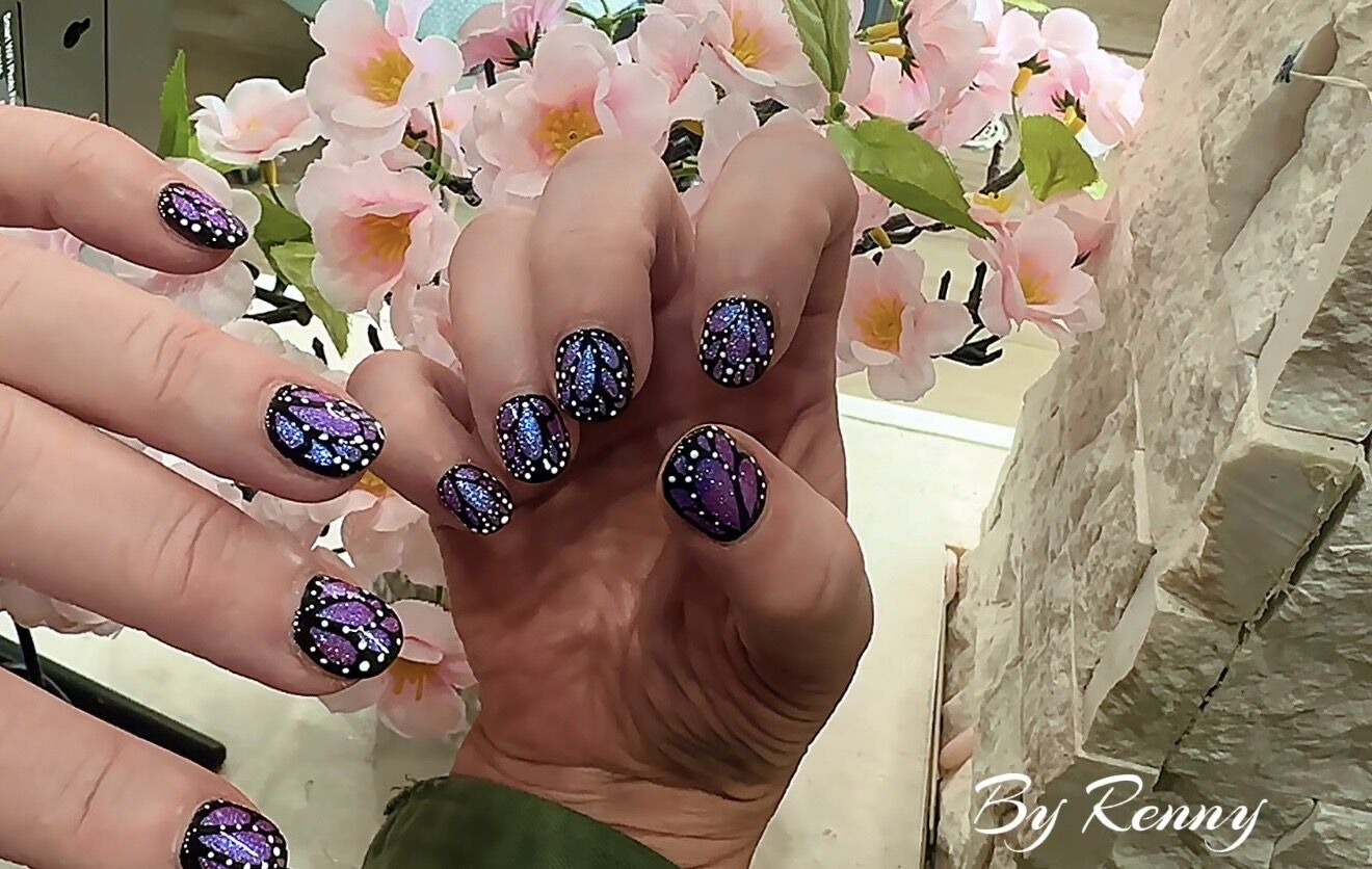 Purple butterfly-wing cat eye nail art with dotted outline, hand-painted in Lone Tree Colorado