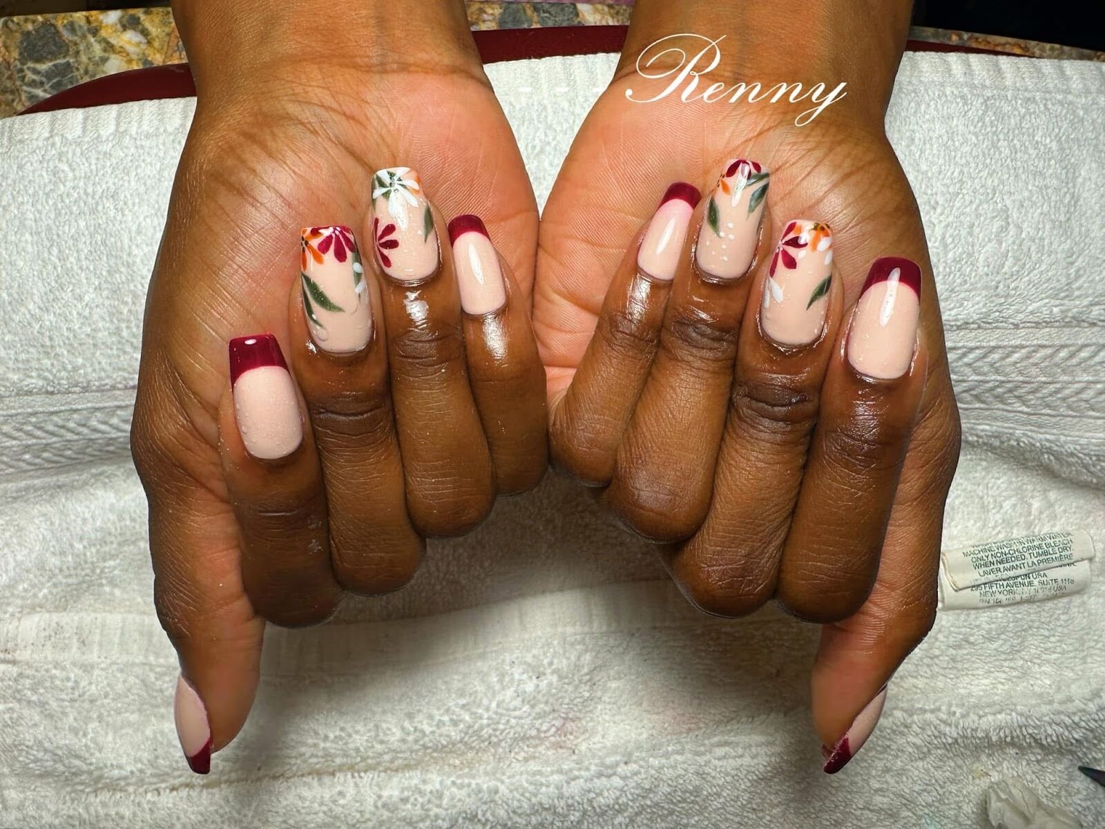 Hand-painted floral nail art with burgundy French tips on natural nails, Ni Hao Nail Studio