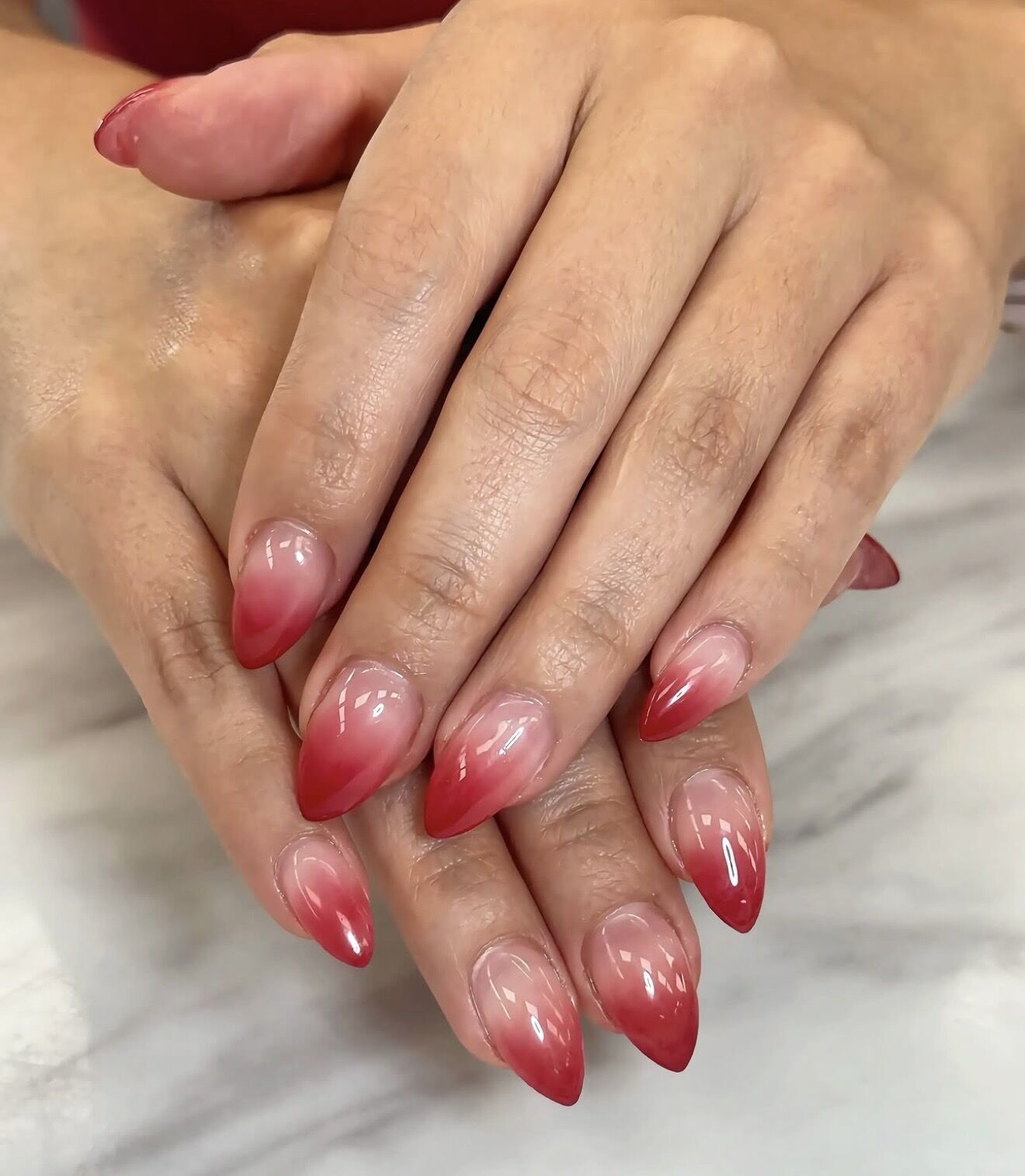 Red ombre almond gel nails fading from nude to deep red, Ni Hao Nail Studio Lone Tree