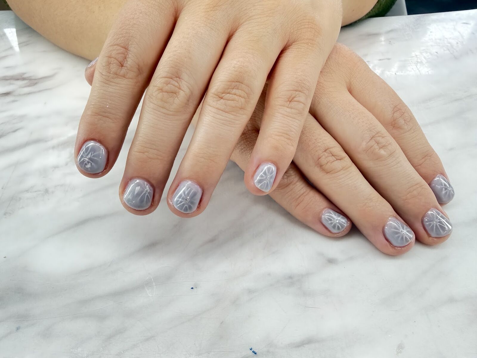 Silver glitter gel manicure on short rounded natural nails in Lone Tree, Colorado